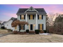 Two-story light green house with a brick walkway and landscaping at 2047 Ferbow St, Creedmoor, NC 27522