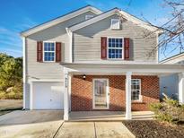Two-story house with gray siding, brick accents, and a covered porch at 3113 Skybrook Ln, Durham, NC 27703