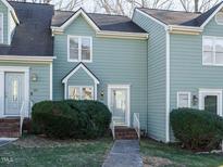 Front view of charming townhome with brick steps and well-manicured landscaping at 431 Oak Run Dr, Raleigh, NC 27606
