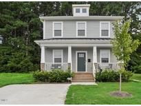 Two-story Craftsman home with gray siding, front porch, and landscaped lawn at 438 S Hillsborough St, Franklinton, NC 27525