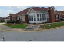 Brick ranch home with sunroom and landscaped front yard at 4712 Fox Fern Ln, Raleigh, NC 27604