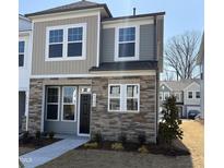 Charming townhome with stone facade, dual siding and meticulous front yard landscaping at 6328 Granite Quarry Dr, Raleigh, NC 27610