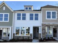 Charming townhome showcases stone accents and light-filled windows on a sunny day at 6330 Granite Quarry Dr, Raleigh, NC 27610