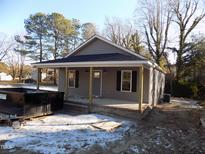 Newly constructed craftsman style home features gray siding and a covered front porch at 104 Halifax Rd, Louisburg, NC 27549