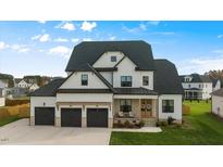 Two-story home with white siding, dark roof, and three-car garage at 1105 Duke Farm Dr, Wake Forest, NC 27587