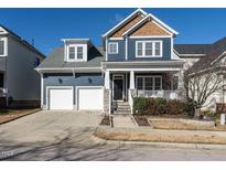 Two-story craftsman style home with a two car garage and front porch at 114 Naperville Dr, Cary, NC 27519