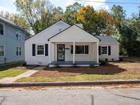 Charming renovated white brick home with a covered porch at 1302 E Jones St, Raleigh, NC 27610