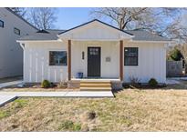 Charming white farmhouse-style home with a covered porch at 2207 Edwin Ave, Durham, NC 27705