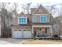 Two-story house with a two-car garage and welcoming front porch at 2224 Madison Creek Dr, Apex, NC 27502