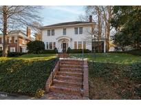 Two story white home with brick walkway, landscaping, and a classic design at 308 Hillcrest Rd, Raleigh, NC 27605