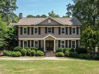 Two-story house with gray siding, dark shutters, and a stone walkway at 505 Annandale Dr, Cary, NC 27511