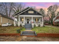 Charming craftsman style home with a front porch and well-manicured lawn at 607 Young St, Henderson, NC 27536