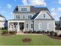 Two-story home with gray siding, white trim, and a landscaped lawn at 1188 Duke Farm Dr, Wake Forest, NC 27587