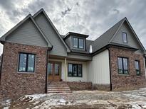 Two-story home with gray and brick exterior, and a covered front porch at 1401 Cottondale Ln, Wake Forest, NC 27587