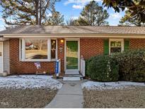 Brick ranch house with attached two-car garage and a landscaped yard at 1501 Mountain View Ct, Hillsborough, NC 27278