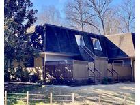 Two-story condo building with brown wooden deck and fenced yard at 215 Summerwalk Cir, Chapel Hill, NC 27517