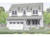 Two-story home with white siding, three-car garage, and front porch at 224 Wash Hollow Dr, Wendell, NC 27591