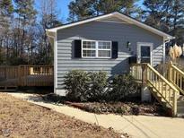 Gray house with wooden deck and steps at 2307 Charles St, Durham, NC 27707