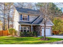 Two-story house with stone accents, a two-car garage, and a well-maintained lawn at 3224 Silver Star Dr, Durham, NC 27713
