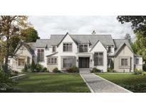 Stunning two-story home with a brick and shingle exterior, large windows, and a walkway at 432 Firefly Overlook, Pittsboro, NC 27312
