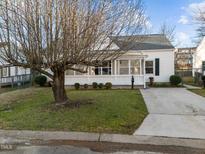 Charming white home featuring a delightful screened-in porch and a well-manicured front yard at 8 Kingston Mill Ct, Durham, NC 27701