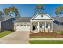 Charming single Gathering home, well-manicured lawn, and a two-car garage at 804 Heathered Farm Way, Apex, NC 27523