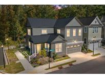 Two-story craftsman home with gray siding, white trim, and a landscaped yard at 924 Noisette Ct, Durham, NC 27713
