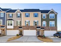 Three-unit townhome building with attached garages and landscaping at 104 Ridgeline Ct, Durham, NC 27703