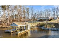 Lakefront home with boathouse and private dock; wooded lot at 261 Willifords Pt Dr, Roxboro, NC 27574