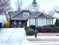Charming blue two-story home with well-manicured landscaping and a cozy front porch at 241 Serenity Hill Cir, Chapel Hill, NC 27516