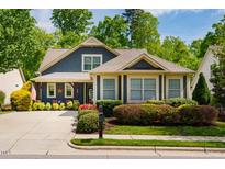 Charming two-story home with a well-manicured lawn, beautiful landscaping, and inviting curb appeal at 241 Serenity Hill Cir, Chapel Hill, NC 27516