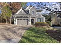 Two-story house with gray siding, a large driveway, and a landscaped lawn at 2500 Shadow Hills Ct Ct, Raleigh, NC 27612