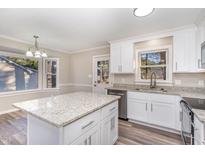 Modern kitchen features white cabinets, granite countertops, and stainless steel appliances at 2805 Chamberlain Rd, Rocky Mount, NC 27803