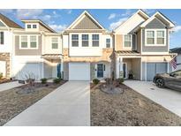 Two story townhome with attached garage and landscaped yard at 31 Burford Way, Angier, NC 27501