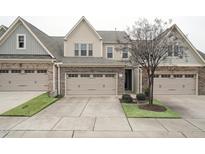 Two-story townhome with stone and siding exterior, two-car garage, and landscaping at 524 Brunello Dr, Wake Forest, NC 27587