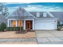 Craftsman style home with gray siding, white trim, and a two-car garage at 135 Abbey View Way, Cary, NC 27519