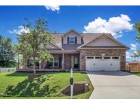 Brick home with two-car garage, and landscaped lawn at 151 Crosscreek Ln, Angier, NC 27501
