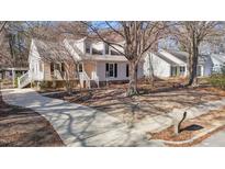 Charming single-Gathering home featuring well-maintained landscaping, light color, and a welcoming entryway at 1536 Maybrook Drive Dr, Raleigh, NC 27610