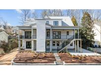 Stunning two-story home featuring a modern design with balconies and landscaped front yard at 3304 Cheswick Dr, Raleigh, NC 27609