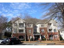 Brick building exterior with multiple units and ample parking at 331 Providence Glen Dr, Chapel Hill, NC 27514