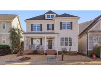 Two-story house with a front porch, brick accents, and landscaping at 439 N Serenity Hill Cir, Chapel Hill, NC 27516