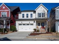 Two-story home with white siding, red door, and attached garage at 512 Beacon Ridge Blvd, Chapel Hill, NC 27516