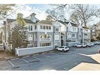 Gray building exterior with ample parking and landscaping at 720 Bishops Park Dr # 305, Raleigh, NC 27605