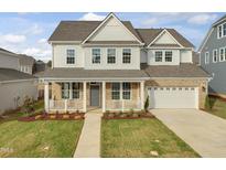 Two-story home with brick and siding, gray door, and a two-car garage at 806 Brookfield Dr, Gibsonville, NC 27249
