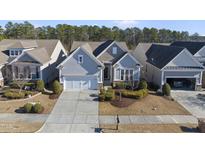 Gray two-story house with a two-car garage and manicured landscaping at 821 Blackfriars Loop, Cary, NC 27519
