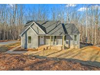 Gray house with front porch and steps, surrounded by woods at 1523 Alta Vista Ln, Graham, NC 27253