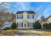 Two-story house with vinyl siding, a two-car driveway and landscaping at 1909 Pinemist Pl, Raleigh, NC 27614