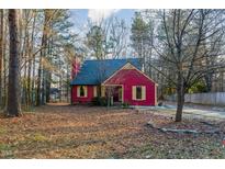 Red house with gray roof and landscaped yard at 211 Dwelling Pl, Knightdale, NC 27545
