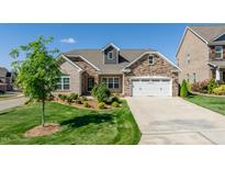 Brick house with a two-car garage and landscaped front yard at 257 Macallan Dr, Burlington, NC 27215