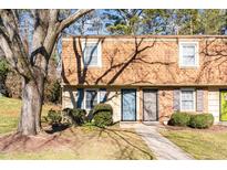 Inviting brick townhouse exterior with landscaping and walkway at 4706 Blue Bird Ct # A, Raleigh, NC 27606